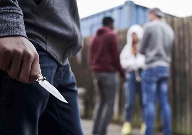 Teenager holds a knife.