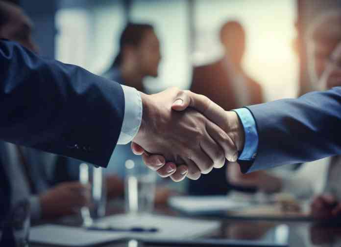 Two business men shake hands in agreement. Two business men shake hands in agreement.
